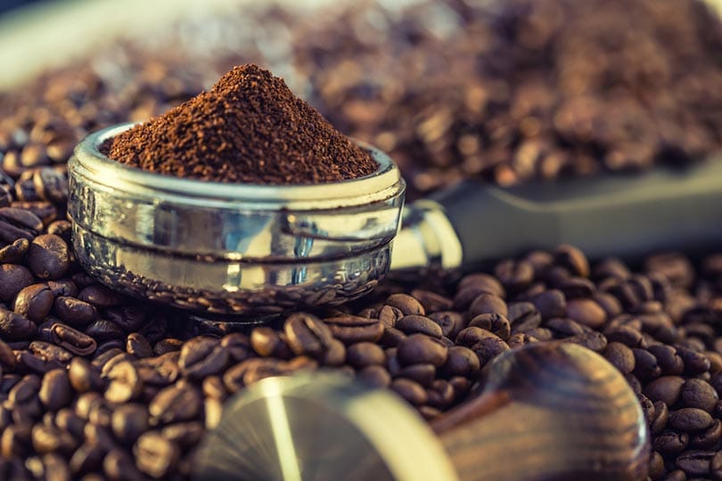 Espresso portafilter filled with freshly ground coffee beans ready for extraction